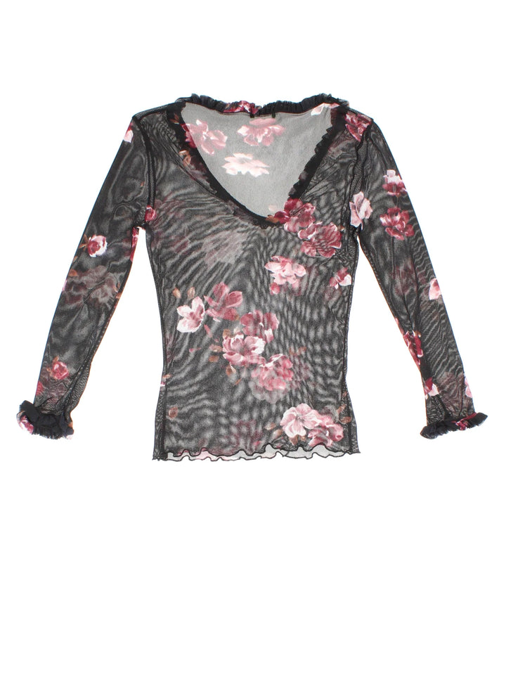 Y2K Floral Mesh Top in a black/pink colourway. V neckline, frill hem and all over floral pattern.