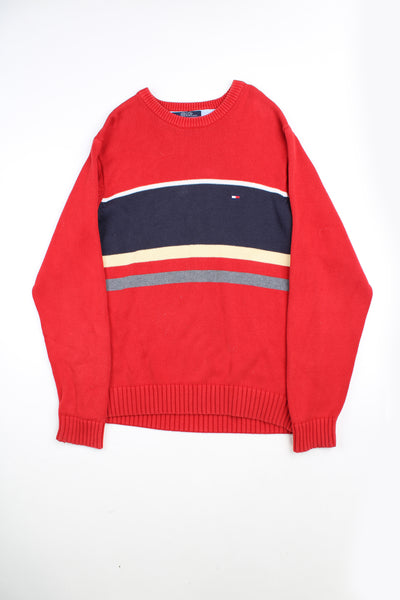 Tommy Hilfiger red crew neck knitted jumper with vertical navy and cream stripes across the front and embroidered logo on the chest.