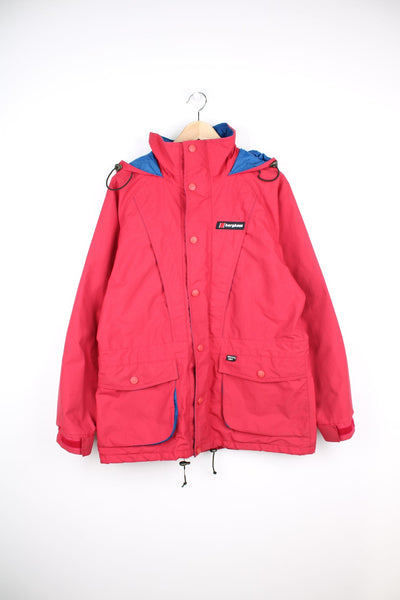Red Berghaus zip through jacket with drawstring waist, embroidered logo and fold away hood.