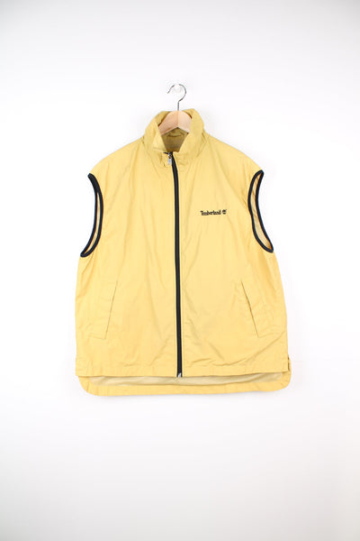 Yellow Timberland zip through gilet. Features embroidered logo on the chest.