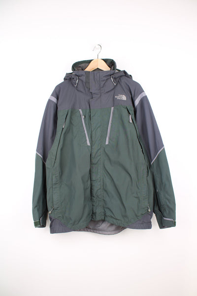 Green and grey The North Face ski jacket. Features embroidered logo on the chest, removable hood, chest and sleeve pockets, inside pockets and snow skirt.