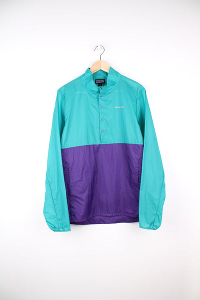 Green and purple Patagonia pullover windbreaker jacket. Features printed logo on the chest and popper fastenings.