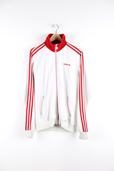 Vintage white and red Adidas tracksuit top, features embroidered logo on the chest, signature three stripes down the arms and a stitched stripe all over