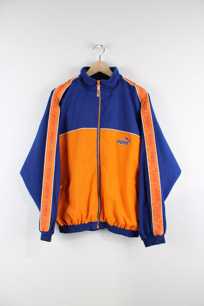 Vintage blue and orange Puma tracksuit top with embroidered logo on the chest and branded stripe down each sleeve. 