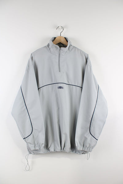 Grey pullover Umbro jacket with embroidered logo and quarter zip. 