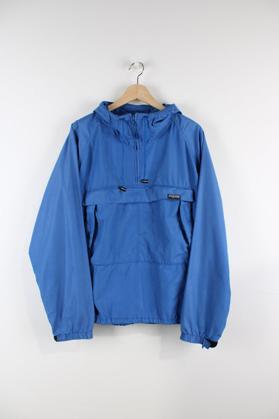 Blue JanSport pullover jacket with quarter zip and and large central pocket.