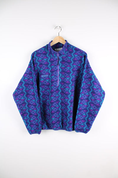 Blue and purple patterned Columbia fleece with half zip and embroidered logo.