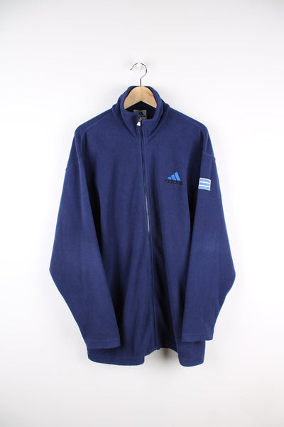 Blue zip through Adidas fleece with embroidered logo on the chest and arm.