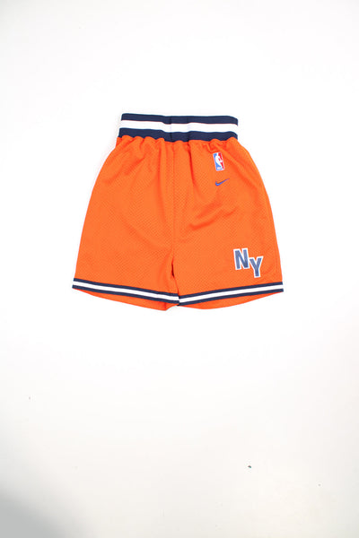 Vintage Nike New York Knicks NBA basketball shorts in orange. Features embroidered logo and drawstring waist.