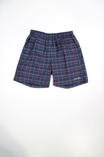 Blue Reebok swim shorts with red and white checks. Features elasticated waist, drawstring and embroidered logo. 
