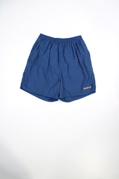Blue Reebok swim shorts with elasticated waist and drawstring. Features embroidered logo.