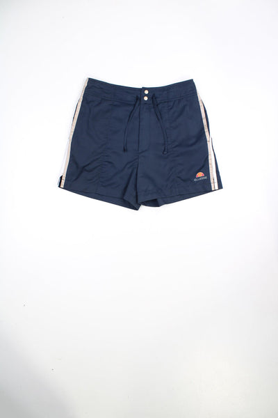 Vintage Ellesse shorts with drawstring waist and popper fastenings. Features stripe detailing and printed logo.