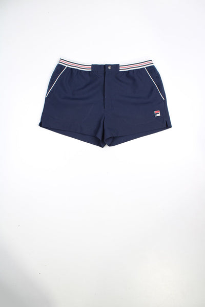 Vintage Fila Hightide 4 shorts in navy. Features striped waistband, embroidered logo and terry towelling detail on the pockets.