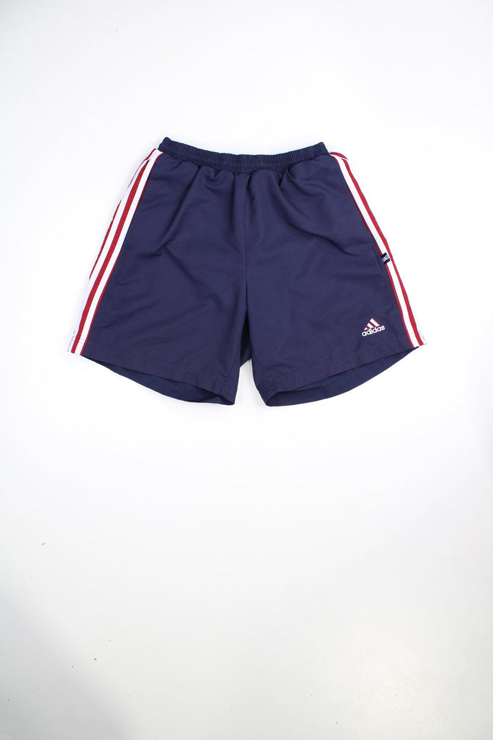 Blue and red Adidas shorts with elasticated waist and drawstring. Features signature three stripes and embroidered logo.