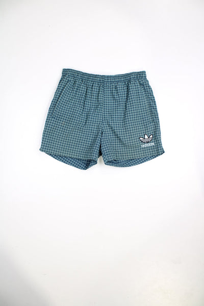 Vintage Adidas shorts with elasticated waist and drawstring in blue check. Features embroidered logo.