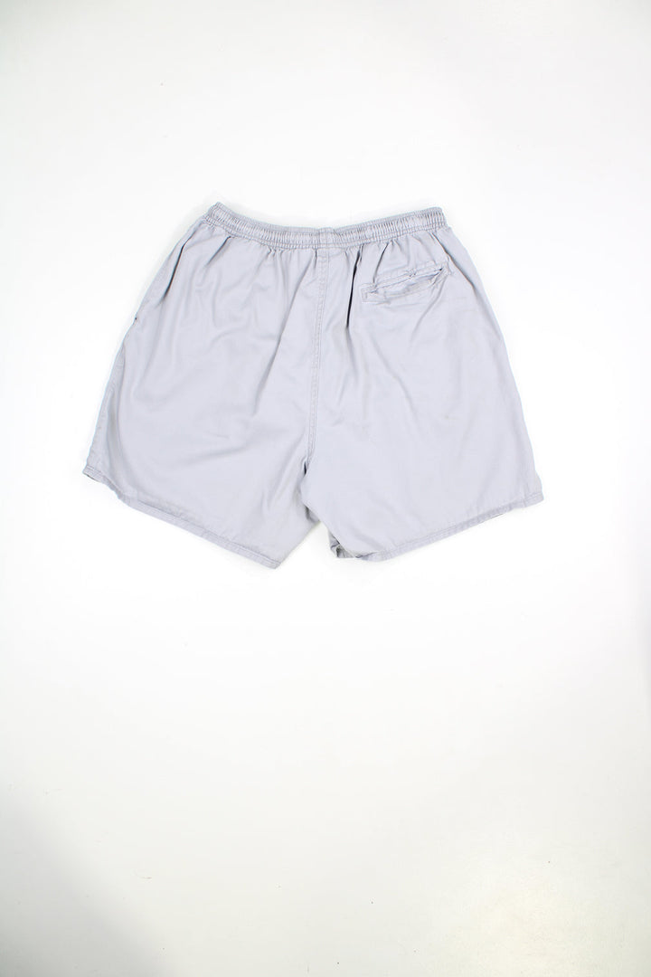 Grey Nike shorts with elasticated waist and drawstring. Features embroidered logo. 