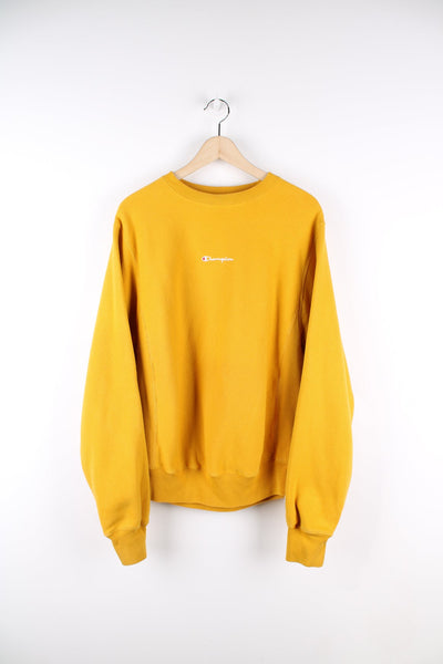 Yellow Champion reverse weave sweatshirt featuring embroidered logo on the chest.