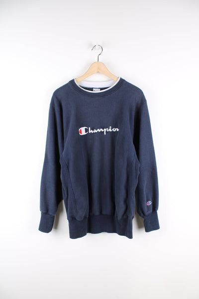 Navy Reverse Weave Champion sweatshirt with embroidered logo across the chest.