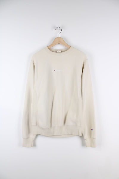 Beige Champion Reverse Weave sweatshirt featuring embroidered logo on the chest.
