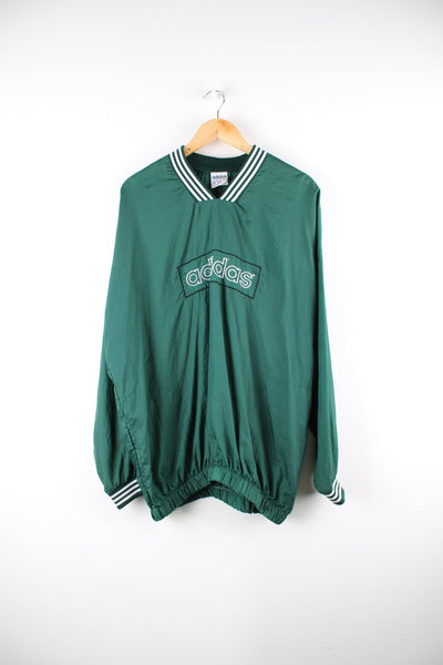 Vintage Adidas drill top in green. Features embroidered spell out logo across the chest.