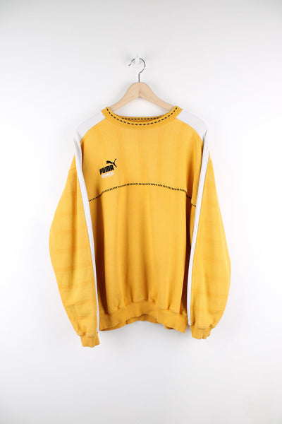 Vintage Puma King yellow sweatshirt. Features embroidered logo on the chest and white stripe detail down the sleeves.