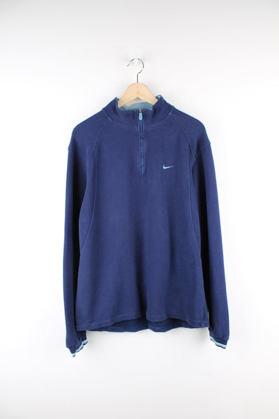 Vintage Nike blue quarter zip sweatshirt with embroidered logo on the chest.