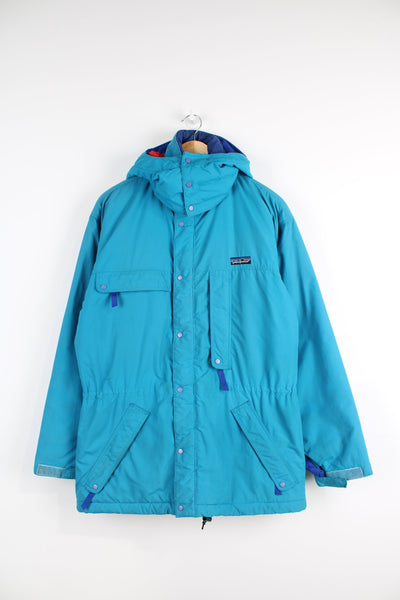 Vintage 90's Patagonia bright blue padded guide coat, features embroidered logo on the chest, mulitple pockets and removable hood