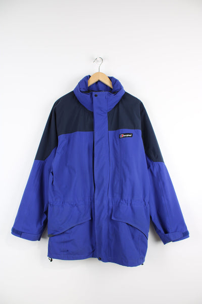 Berghaus blue zip through outdoor jacket, features multiple pockets and foldaway hood