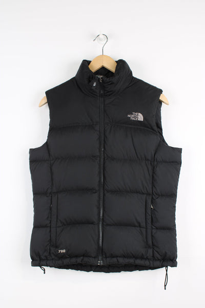 The North Face 700 Women's all black zip through puffer gilet, features signature logo on the chest