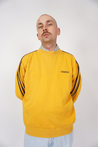 Vintage 90s Adidas yellow crewneck sweatshirt with embroidered logo and brown piping down both sleeves