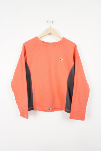 Y2K coral pink Nike crewneck sweatshirt with embroidered logo on chest and grey side panels. Also has elastic drawstring around the hem.