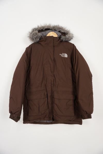 The North Face brown hooded down coat with multiple pockets, drawstring hem and faux fur trimmed hood.