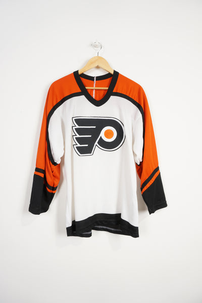 Vintage 90s CCM black and orange Philadelphia hockey jersey with embroidered logo on the front