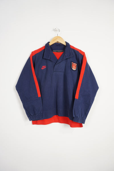 Vintage 1995-96 Nike Premier Arsenal blue and red cotton drill top. With embroidered logo/badge on the front and print logo on the back
