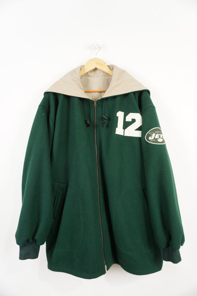 Vintage 90's New York Jets green hooded varsity jacket, reversible. Embroidered logo and name on front, back and sleeve. Good Condition, 2 small holes on back of right sleeve (see pictures) Size in Label: XL