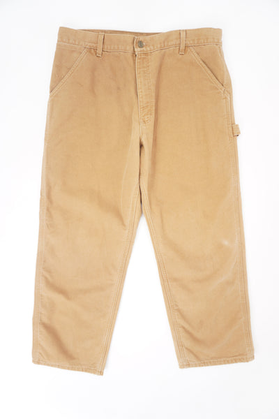 Tan Carhartt heavy duty cotton relaxed fit carpenter jeans with multiple pockets