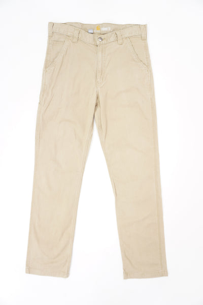 Light tan Carhartt relaxed fit, straight leg  jeans with multiple pockets