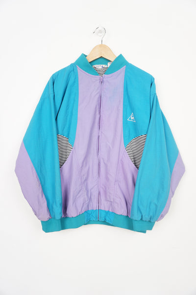 Vintage 1980's Le Coq Sportif turquoise and purple shell jacket with embroidered logo on the chest 