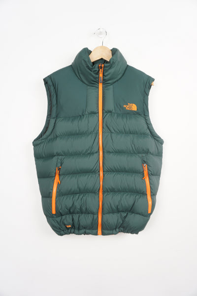 The North Face 700 green and orange down gilet with embroidered logos, drawstring hem and double pockets 