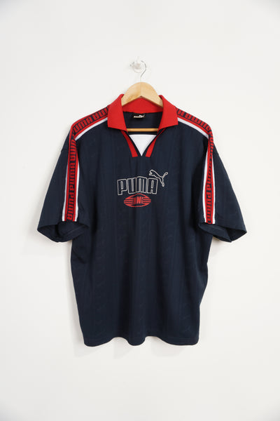 Vintage Puma King Navy Blue Polo Jersey with red details around collar, raised logo on chest Item in good condition, slight discolouration on logo Size in Label: L