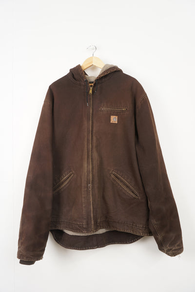Brown heavy duty cotton hooded Carhartt jacket with embroidered logo on the pocket and fleece lining