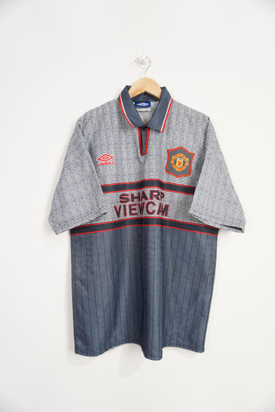 The away shirt worn by Manchester United during the 95/96 season where they won the league and FA Cup.