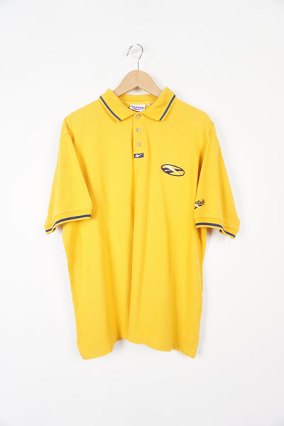 90's Reebok all yellow polo shirt with embroidered logo on the chest