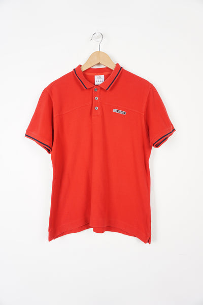 Red Adidas polo shirt with embroidered logo on the chest