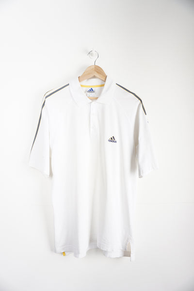 Vintage 1990s Adidas Polo Shirt with embroidered logo and grey/yellow strips down sleeves. Item in good condition, small mark on right shoulder and very small signs of yellowing around neck line Size in Label: L