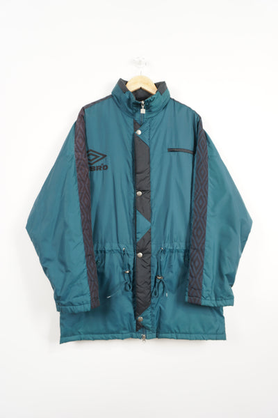 Vintage turquoise Umbro coat with embroidered logo on the chest , foldaway hood and ribbon down sleeves 
