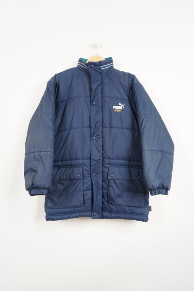 Navy blue Puma King Puffer coat with embroidered logo on the chest and foldaway hood 