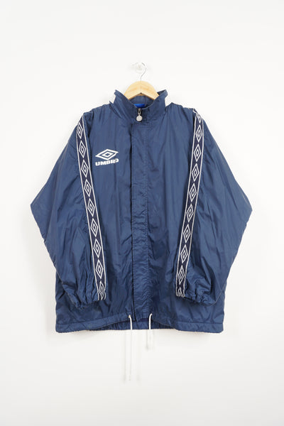 Vintage navy blue Umbro Coat with fleece lining, embroidered logo on the chest ,foldaway hood and ribbon down sleeves 