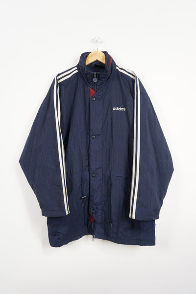 Vintage 90's navy blue Adidas padded sports coat, with embroidered logo on the chest and three stripes down the sleeve 