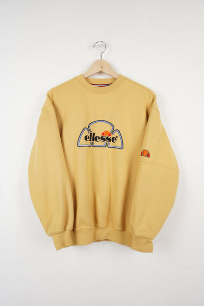 Ellesse yellow crewneck sweatshirt, with embroidered logo across the front